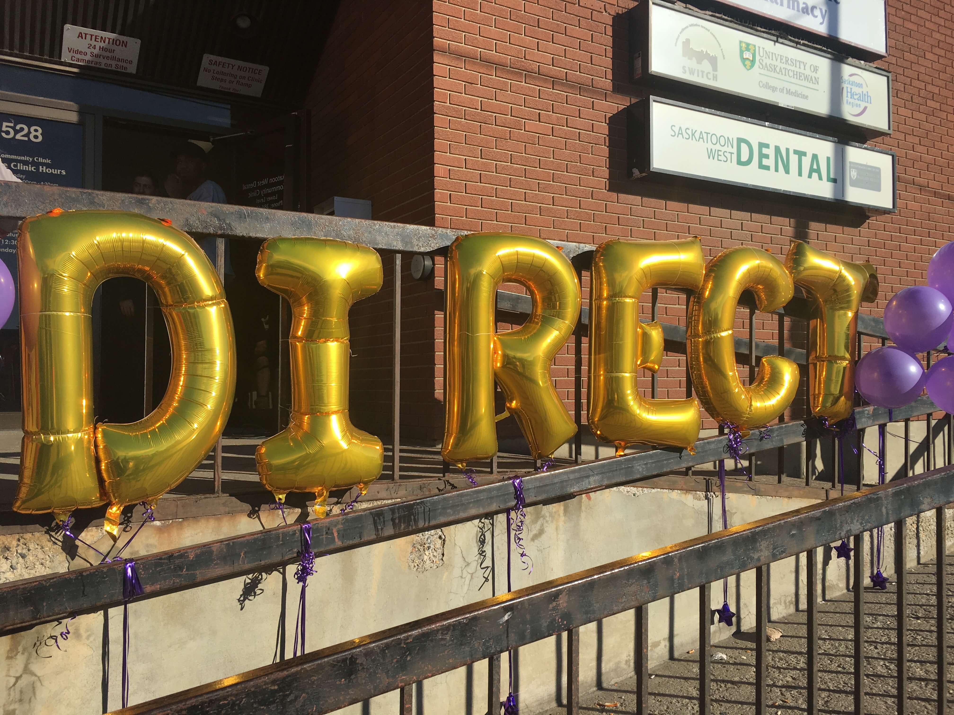 A little dental floss was all that was needed to keep the wind from wreaking havoc on the opening day balloons for DIRECT Dental. Photo by Stacey Schewaga.